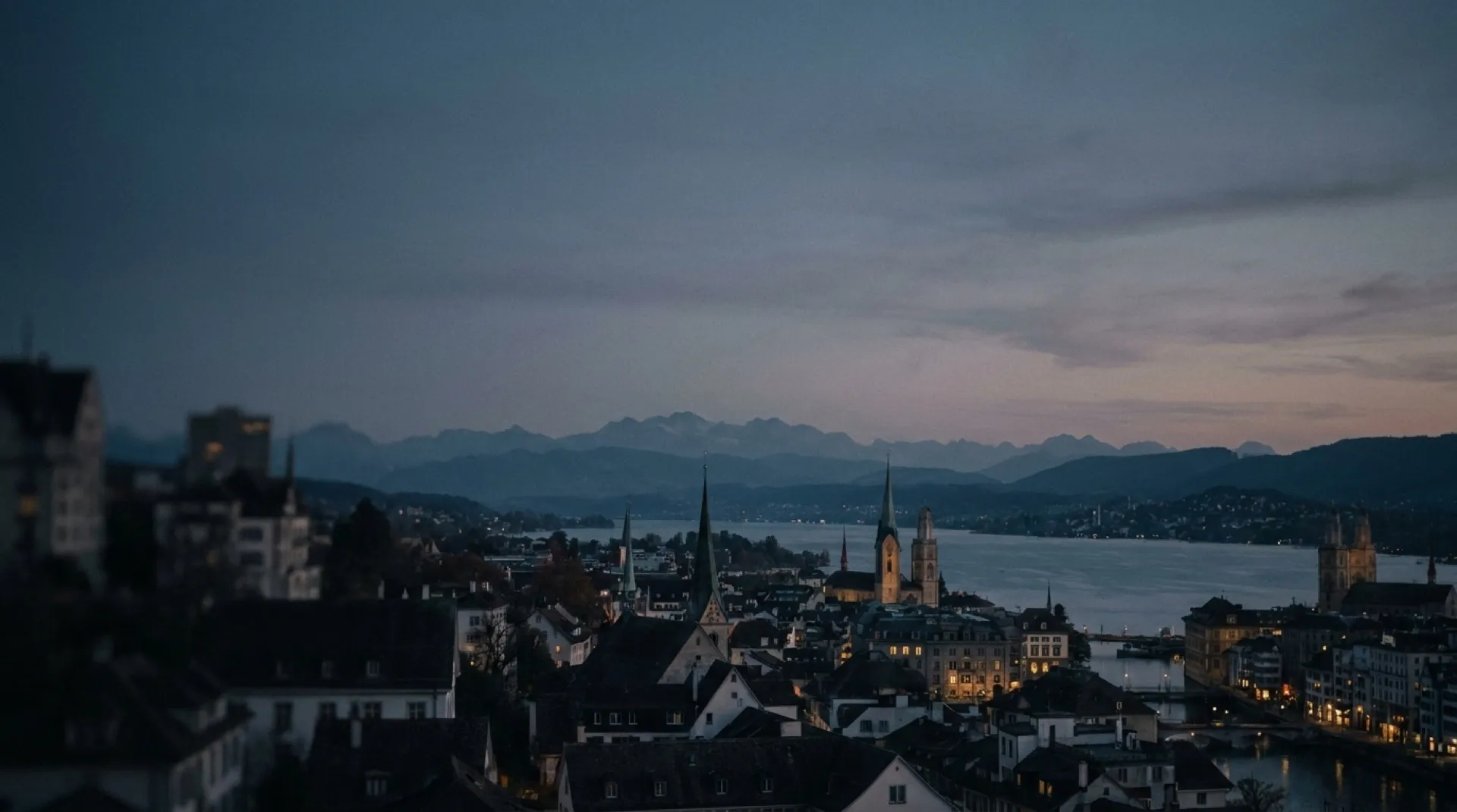 Zurich at dawn — lake, old town and the Alps beyond