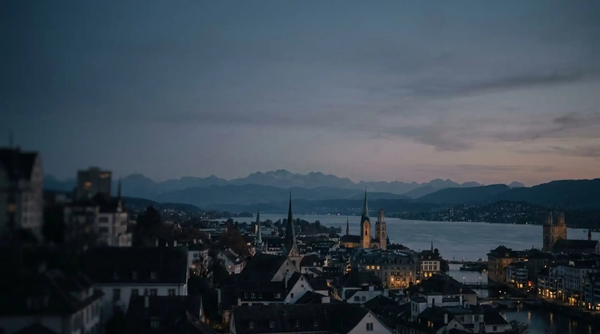 Zurich at dawn — lake, old town and the Alps beyond